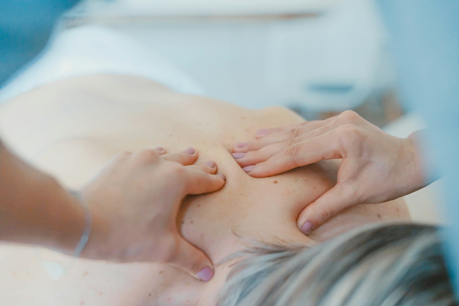 Sandesha providing hands-on physical therapy